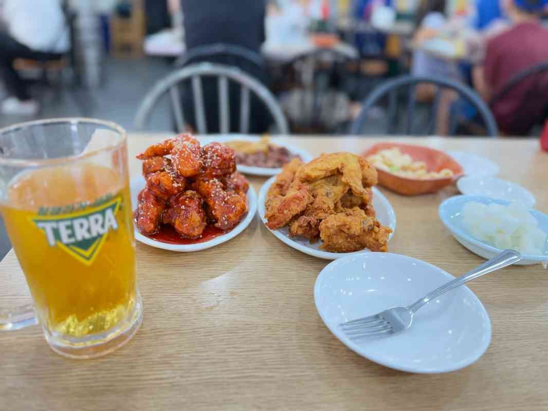 Original and seasoned fried chicken with side dishes and beer at Yongseong Tongdak in Suwon